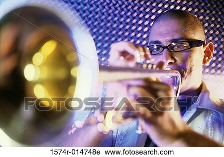 Close-up of a young man playing the trumpet View Large Photo Image Stock Image - Close-up of a young man playing the trumpet. Fotosearch