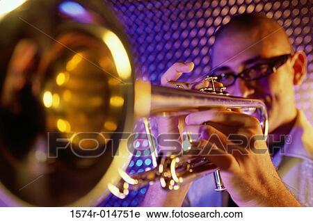 Close-up of a young man playing the trumpet View Large Photo Image Stock Image - Close-up of a young man playing the trumpet. Fotosearch