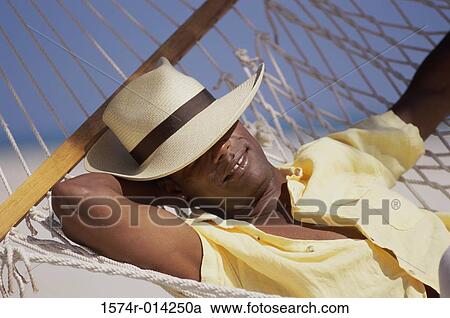 Close-up of a young man resting in a hammock View Large Photo Image Stock Image - Close-up of a young man resting in a hammock. Fotosearch