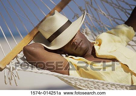 Close-up of a young man resting in a hammock View Large Photo Image Stock Image - Close-up of a young man resting in a hammock. Fotosearch