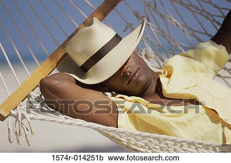 Close-up of a young man resting in a hammock View Large Photo Image Stock Image - Close-up of a young man resting in a hammock. Fotosearch