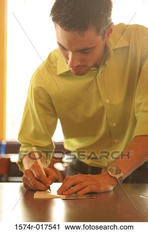 Close-up of a young man signing a bill View Large Photo Image Stock Image - Close-up of a young man signing a bill. Fotosearch