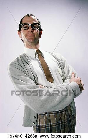 Close-up of a young man standing with his arms crossed View Large Photo Image Stock Image - Close-up of a young man standing with his arms crossed. Fotosearch