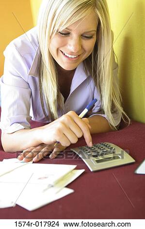 Close-up of a young woman using a calculator View Large Photo Image Picture - Close-up of a young woman using a calculator. Fotosearch