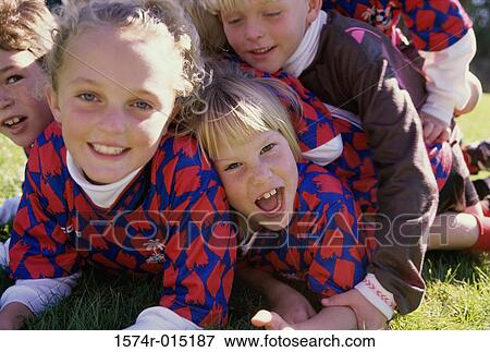 Close-up of boys and girls lying on the grass View Large Photo Image Stock Photo - Close-up of boys and girls lying on the grass. Fotosearch