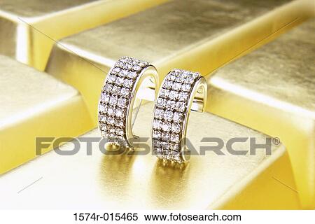 Close-up of diamond earrings on gold bars View Large Photo Image Stock Photography - Close-up of diamond earrings on gold bars. Fotosearch