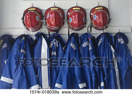 Close-up of fire fighter's helmets and fire protective suits hanging on hooks View Large Photo Image Stock Image - Close-up of fire fighter's helmets and fire protective suits hanging on hooks. Fotosearch