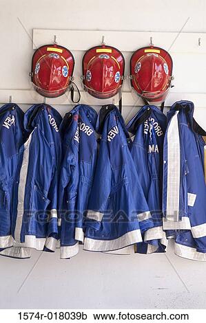 Close-up of firefighter's helmets and fire protective suits hanging on hooks View Large Photo Image Stock Image - Close-up of firefighter's helmets and fire protective suits hanging on hooks. Fotosearch