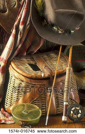 Stock Photography - Close-up of fishing equipment and a hat. Fotosearch