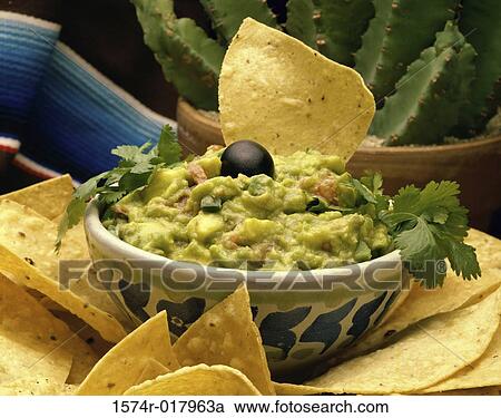 Stock Image - Close-up of guacamole with tortilla chips. Fotosearch