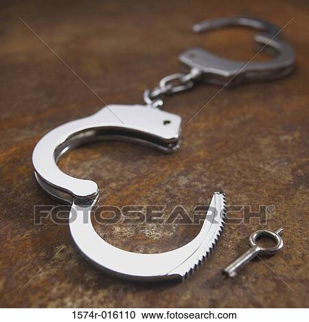 Close-up of handcuffs View Large Photo Image Stock Image - Close-up of handcuffs. Fotosearch