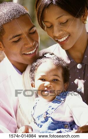 Picture - Close-up of parents and their daughter smiling. Fotosearch