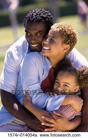 Close-up of parents and their daughter smiling View Large Photo Image Stock Image - Close-up of parents and their daughter smiling. Fotosearch