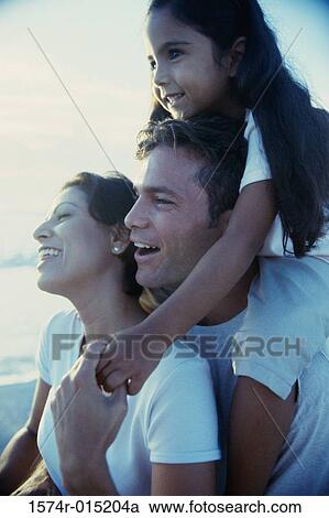 Close-up of parents and their daughter smiling View Large Photo Image Stock Image - Close-up of parents and their daughter smiling. Fotosearch