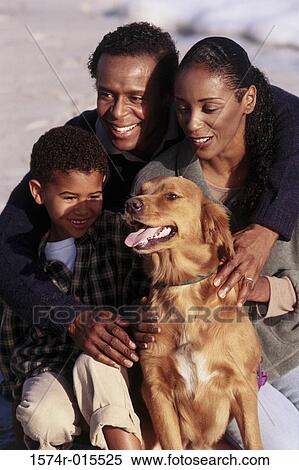 Close-up of parents and their son playing with a dog View Large Photo Image Stock Photography - Close-up of parents and their son playing with a dog. Fotosearch