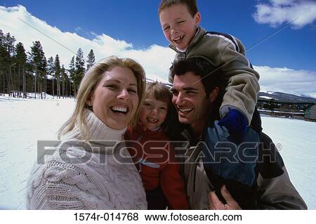 Close-up of parents smiling with their son and daughter View Large Photo Image Stock Photo - Close-up of parents smiling with their son and daughter. Fotosearch