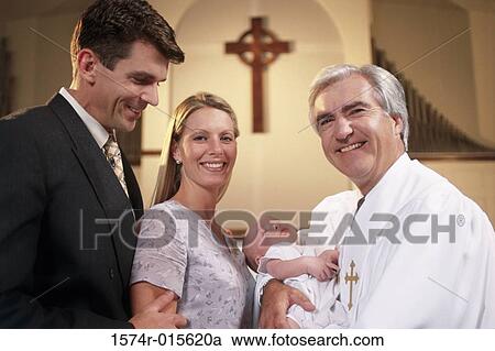 Close-up of parents with their son at a baptism View Large Photo Image Stock Image - Close-up of parents with their son at a baptism. Fotosearch