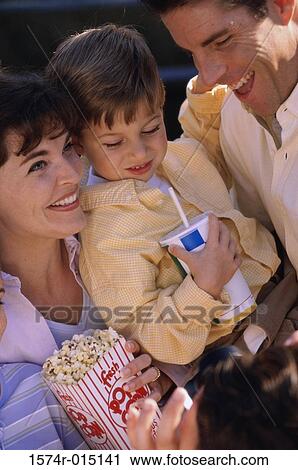 Stock Image - Close-up of parents with their son smiling. Fotosearch