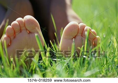 Close-up of the sole of a person's feet lying on grass View Large Photo Image Stock Photo - Close-up of the sole of a person's feet lying on grass. Fotosearch