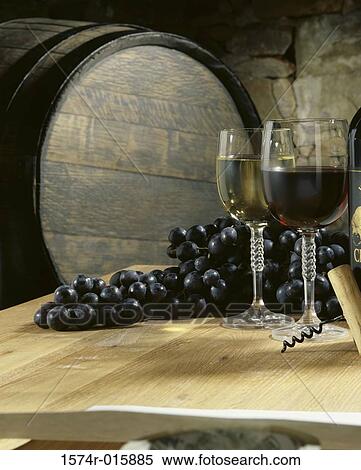 Close-up of two wineglasses and grapes on a table in a cellar View Large Photo Image Stock Photography - Close-up of two wineglasses and grapes on a table in a cellar. Fotosearch