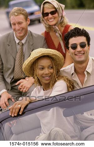 Close-up of two young couples sitting in a car View Large Photo Image Stock Photograph - Close-up of two young couples sitting in a car. Fotosearch