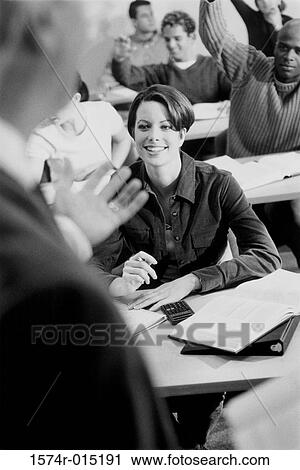 College students sitting in a classroom with their hands raised View Large Photo Image Stock Image - College students sitting in a classroom with their hands raised. Fotosearch