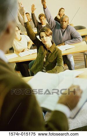 College students sitting in a classroom with their hands raised View Large Photo Image Stock Photography - College students sitting in a classroom with their hands raised. Fotosearch
