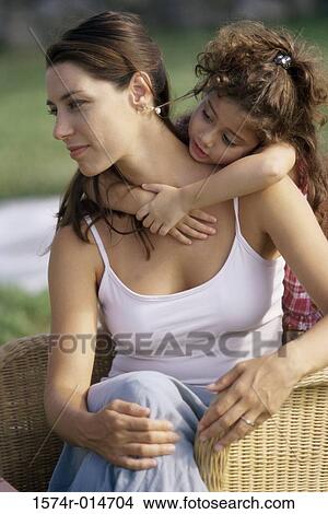 Picture - Daughter hugging her mother from behind. Fotosearch