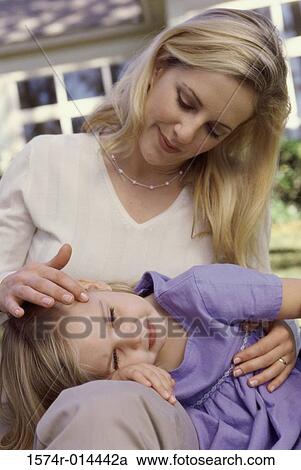 Daughter resting her head on her mother's lap View Large Photo Image Stock Image - Daughter resting her head on her mother's lap. Fotosearch