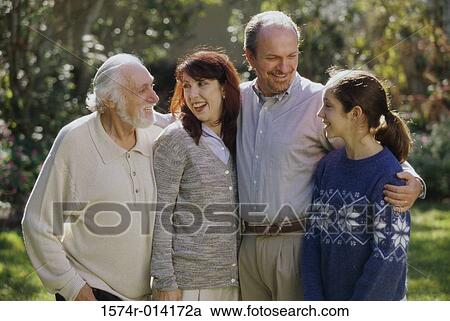 Daughter standing with her parents and grandfather in a park View Large Photo Image Stock Image - Daughter standing with her parents and grandfather in a park. Fotosearch