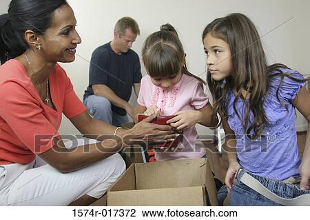 Family unpacking in their new house View Large Photo Image Stock Image - Family unpacking in their new house. Fotosearch