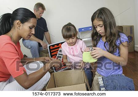 Family unpacking in their new house View Large Photo Image Stock Image - Family unpacking in their new house. Fotosearch