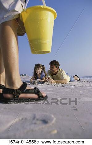 Father and daughter making a sand castle on the beach View Large Photo Image Stock Image - Father and daughter making a sand castle on the beach. Fotosearch