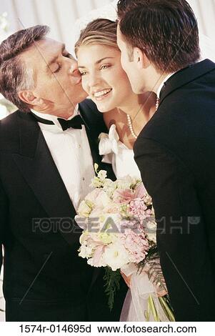 Father and groom kissing the bride View Large Photo Image Stock Image - Father and groom kissing the bride. Fotosearch