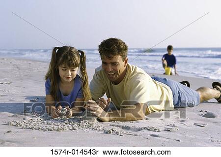 Father and his daughter making a sand castle on the beach View Large Photo Image Stock Photography - Father and his daughter making a sand castle on the beach. Fotosearch