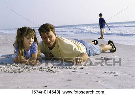 Father and his daughter writing in sand on the beach View Large Photo Image Stock Image - Father and his daughter writing in sand on the beach. Fotosearch