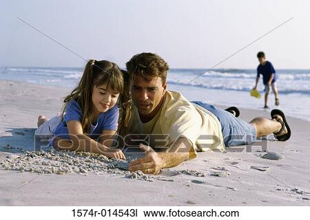 Father and his daughter writing in sand on the beach View Large Photo Image Stock Image - Father and his daughter writing in sand on the beach. Fotosearch
