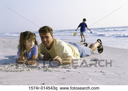 Father and his daughter writing in sand on the beach View Large Photo Image Stock Photography - Father and his daughter writing in sand on the beach. Fotosearch