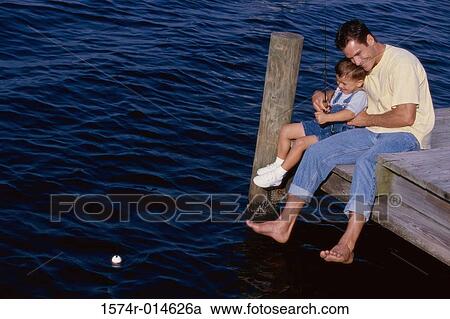 Father and son sitting on a pier and fishing View Large Photo Image Stock Image - Father and son sitting on a pier and fishing. Fotosearch