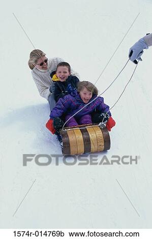Father pulling his family on a sled View Large Photo Image Stock Image - Father pulling his family on a sled. Fotosearch