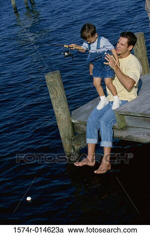 Father teaching his son to fish View Large Photo Image Stock Image - Father teaching his son to fish. Fotosearch