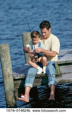 Father teaching his son to fish View Large Photo Image Stock Image - Father teaching his son to fish. Fotosearch