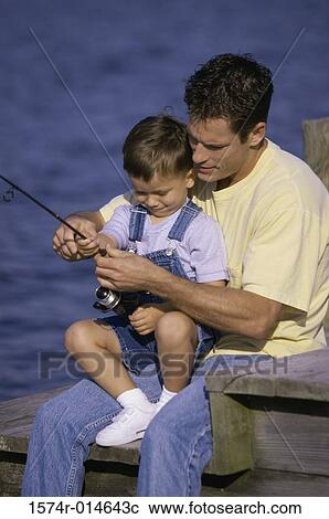 Father teaching his son to fish View Large Photo Image Stock Image - Father teaching his son to fish. Fotosearch