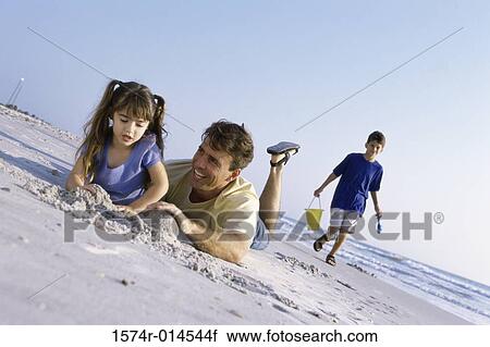 Father with his children on the beach View Large Photo Image Stock Image - Father with his children on the beach. Fotosearch