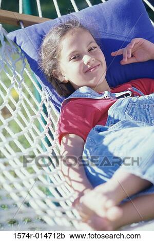 Girl lying in a hammock View Large Photo Image Stock Image - Girl lying in a hammock. Fotosearch