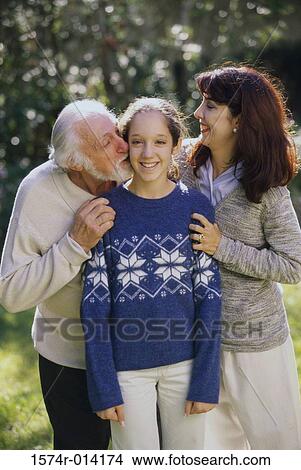 Grandfather kissing his granddaughter with her mother standing beside her View Large Photo Image Picture - Grandfather kissing his granddaughter with her mother standing beside her. Fotosearch