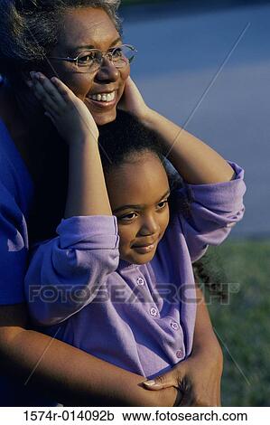 Stock Image - Grandmother smiling with her granddaughter. Fotosearch