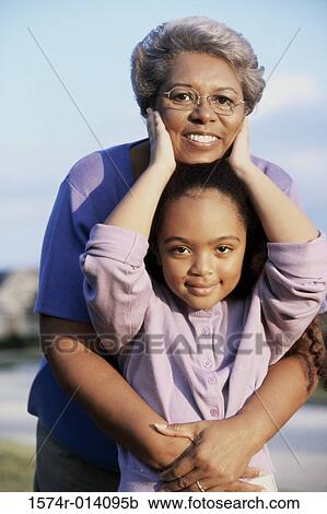 Stock Image - Grandmother smiling with her granddaughter. Fotosearch