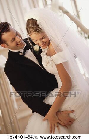 Groom carrying his bride View Large Photo Image Stock Image - Groom carrying his bride. Fotosearch