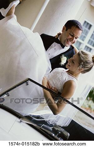 Groom carrying his bride View Large Photo Image Stock Image - Groom carrying his bride. Fotosearch